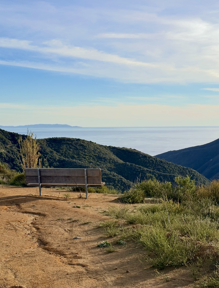 A bench on a ridge looking out over the ocean